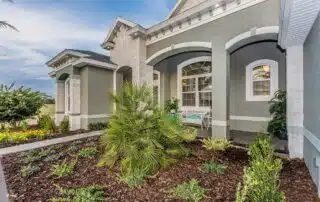 Beautiful exterior of Florida home and amazing landscaping with tropical foliage