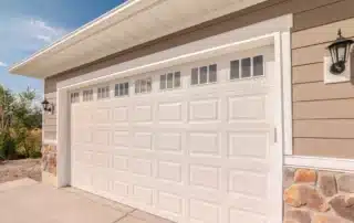 Different types of garage doors installed on residential and commercial properties in Connecticut showcasing various styles and designs