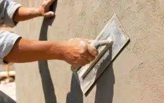 Professional Stucco Repair Contractor Restoring A Damaged Exterior Wall On A Home In Destin, FL To Improve Durability And Appearance.